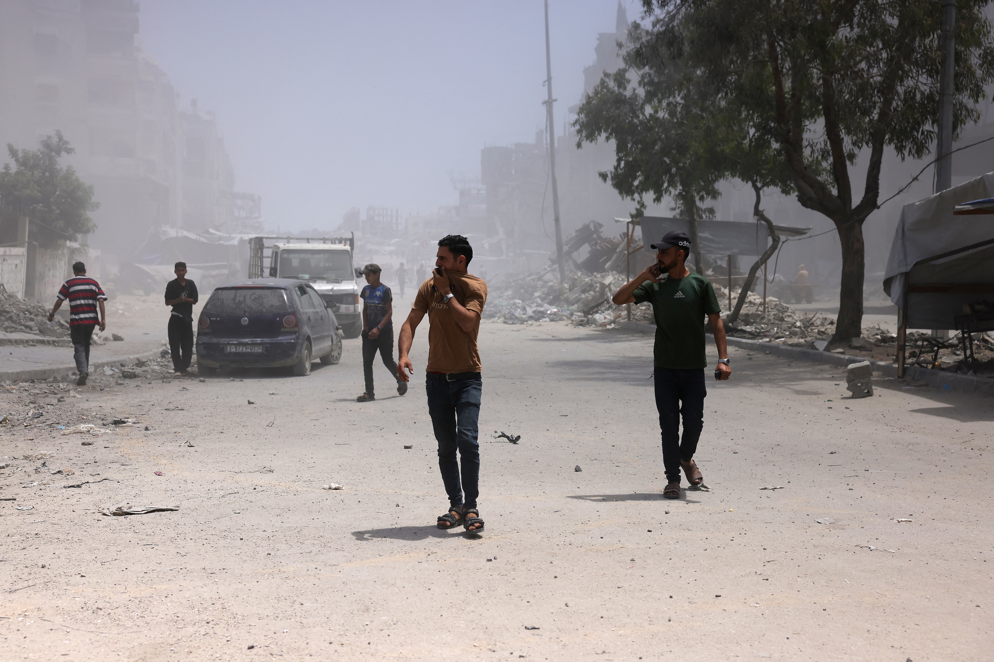 Palestinians cover their faces as they walk amid dust and smoke after an Israeli strike hit a nearby house west of Jabalia, in the northern Gaza Strip, June 1, 2025. (AFP)