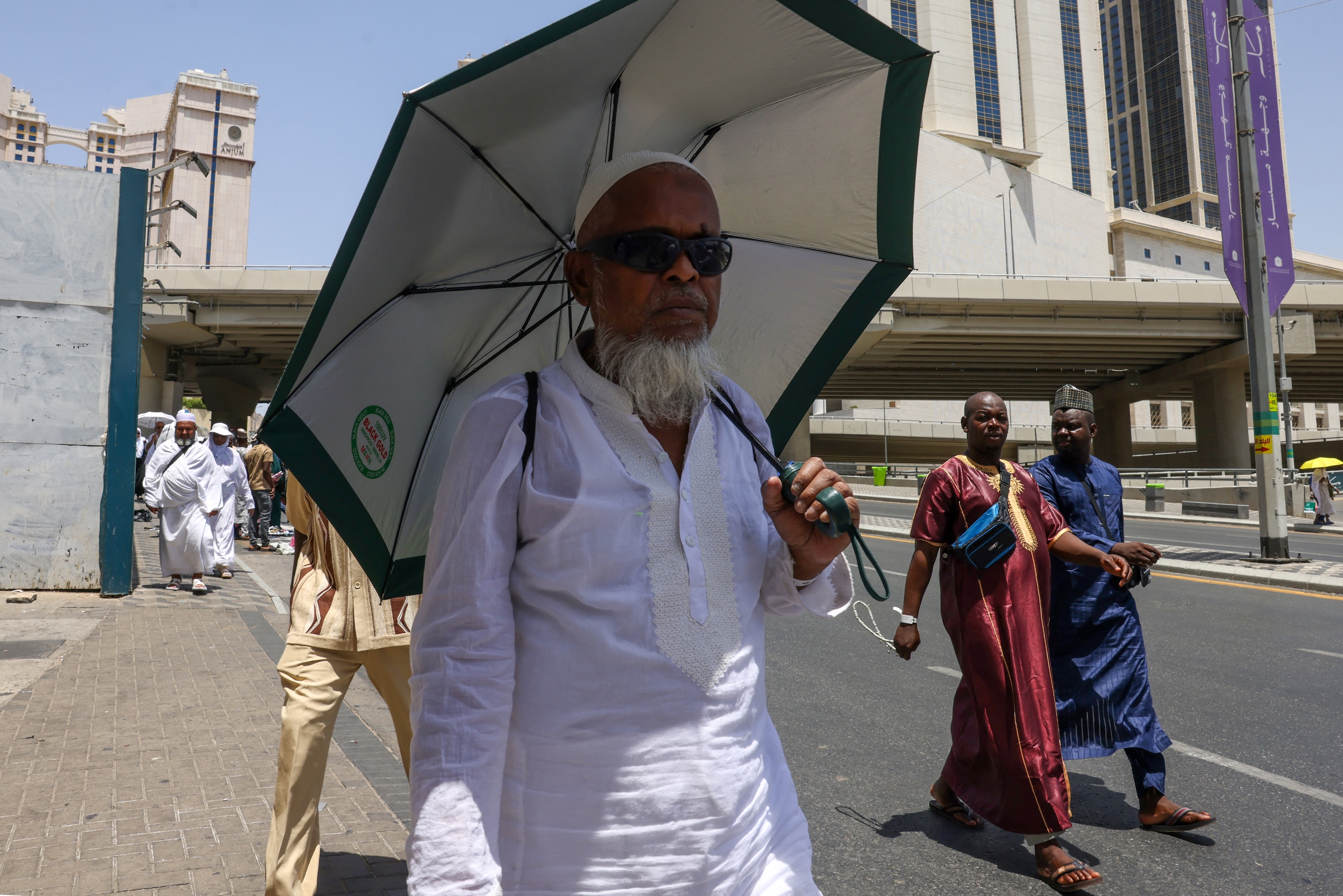 Muslim worshippers walk on the streets in Saudi Arabia's holy city of Makkah during the annual Hajj pilgrimage, June 2, 2025. (AFP)