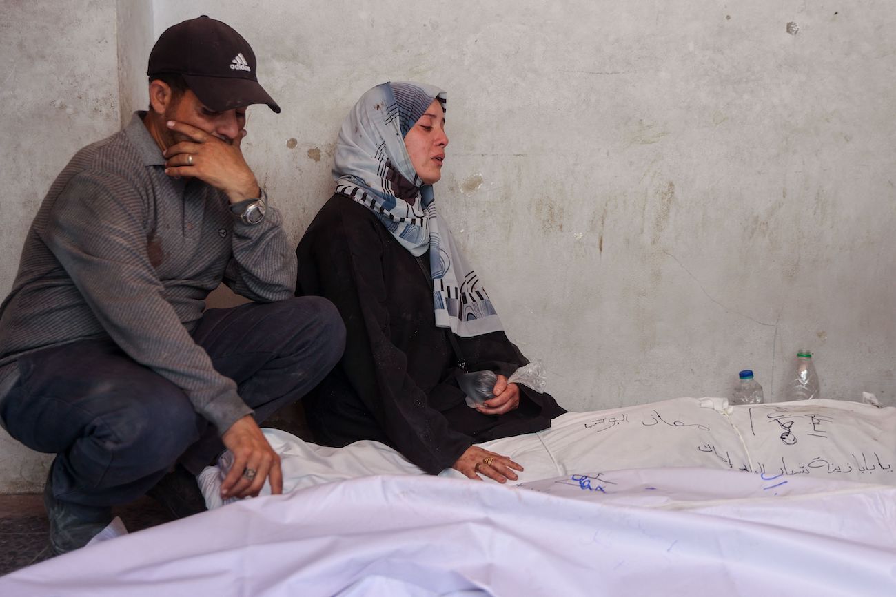 Palestinians mourn over the shrouded bodies of loved ones killed during an Israeli strike that targeted the home of the Al-Bursh family in Jabalia, Gaza Strip on June 2, 2025. (AFP)