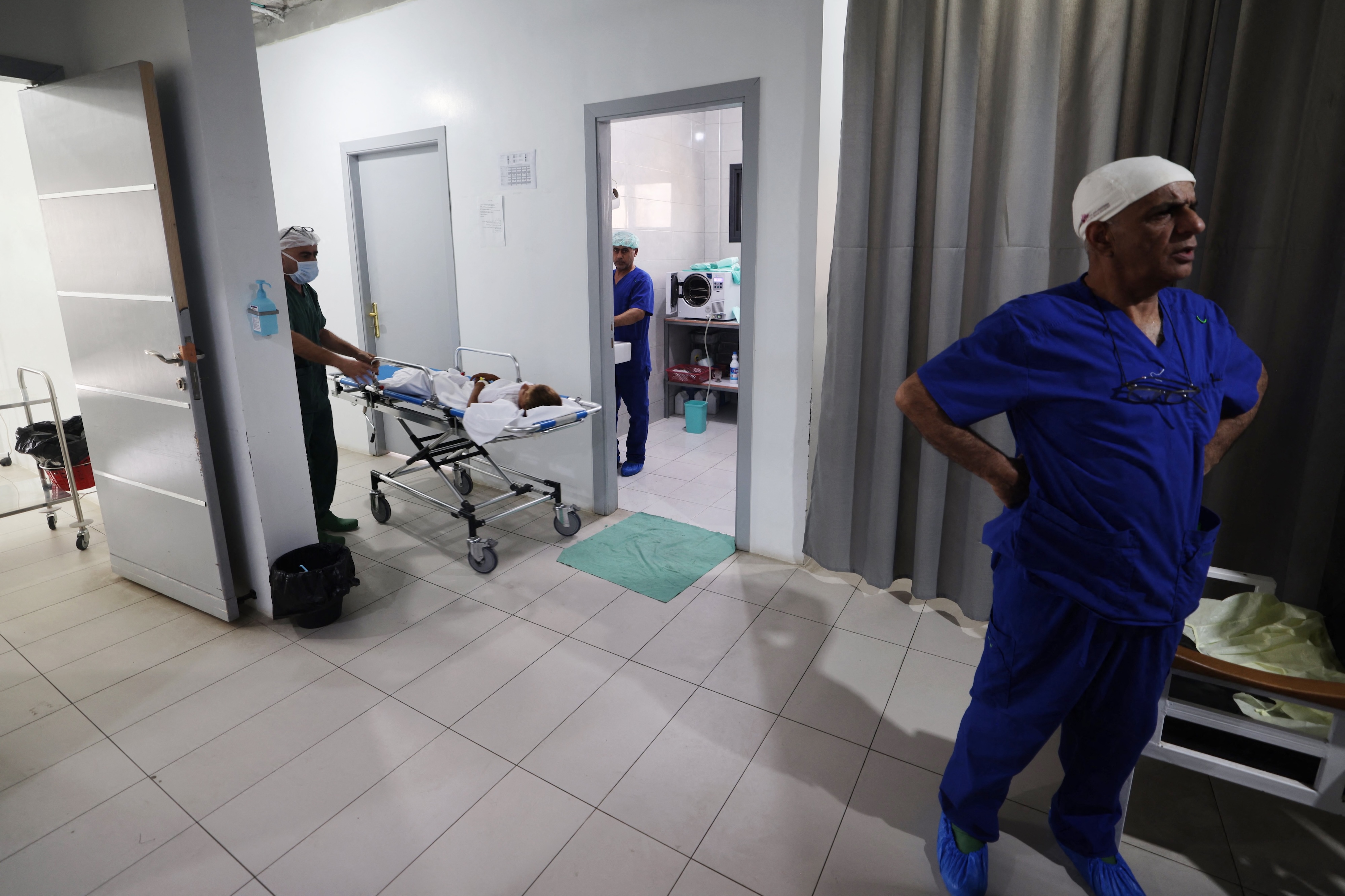 Medics care for patients at a clinic set up by Doctors Without Borders (MSF) treating severe injuries and burns sustained in Israeli bombardment, at the Rafah Indonesian Field Hospital in Rafah in the southern Gaza Strip. (File/AFP)