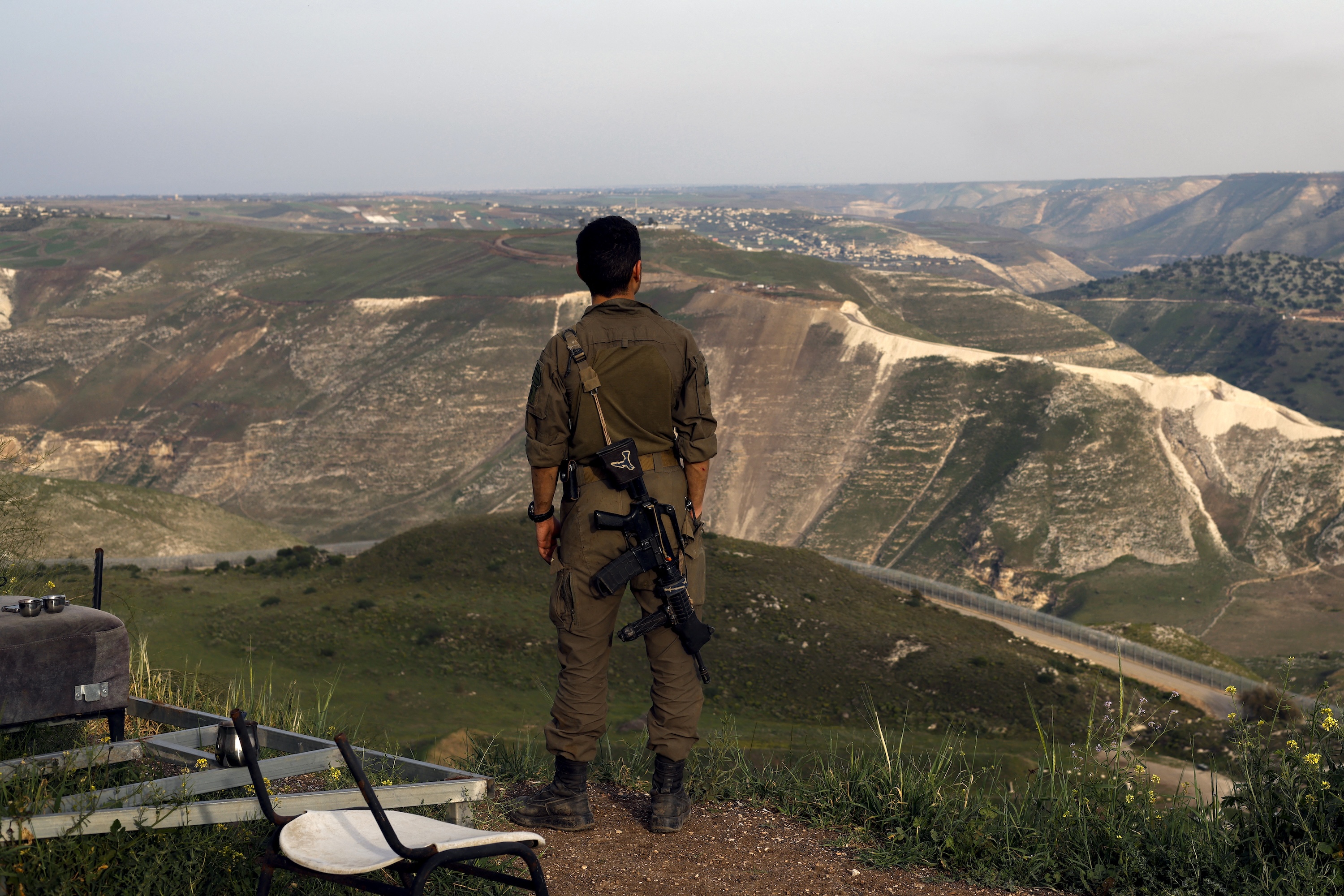 An Israeli soldier stands at a lookout point in the Israel-occupied and annexed Golan Heights overlooking southern Syria, March 25, 2025. (AFP)