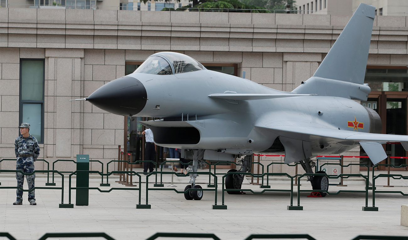 A soldier stands next to a J-10 fighter jet during an exhibition for the 90th anniversary of the founding of the People's Liberation Army (PLA) outside Military Museum of the Chinese People's Revolution in Beijing, China, on July 28, 2017. (REUTERS/File)