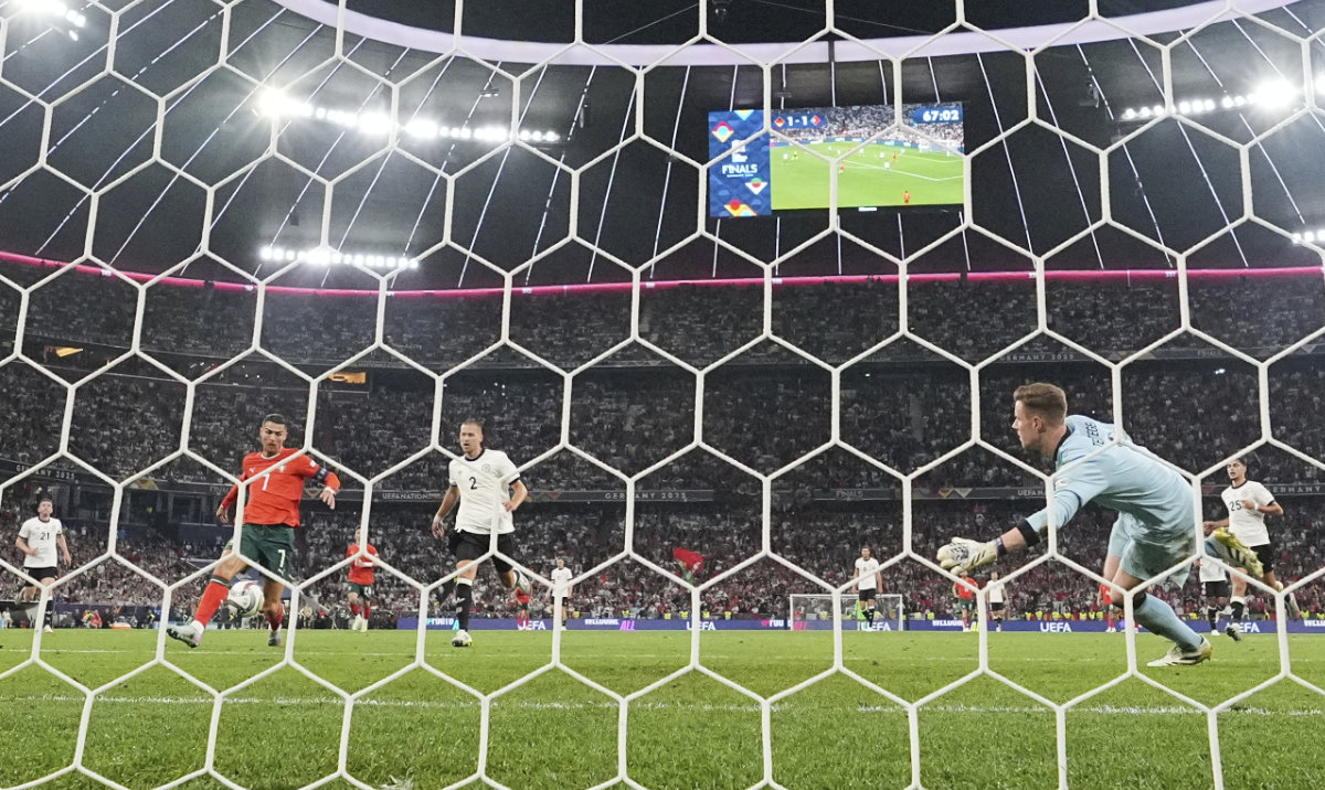 Portugal’s Cristiano Ronaldo, 2nd left, scores his side’s second goal past Germany’s goalkeeper Marc-Andre ter Stegen during the Nations League semifinal between Portugal and Germany at the Munich Football Arena, in Munich, Wednesday. (AP)