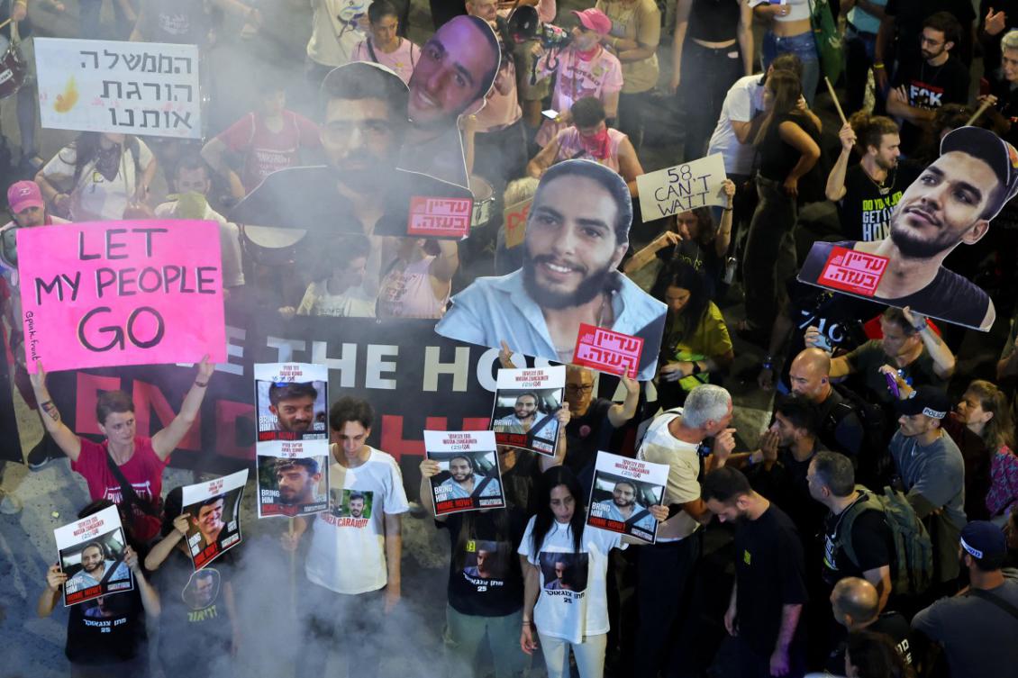 Demonstrators hold placards and portraits of Israeli hostages held in the Gaza Strip. (File/AFP)