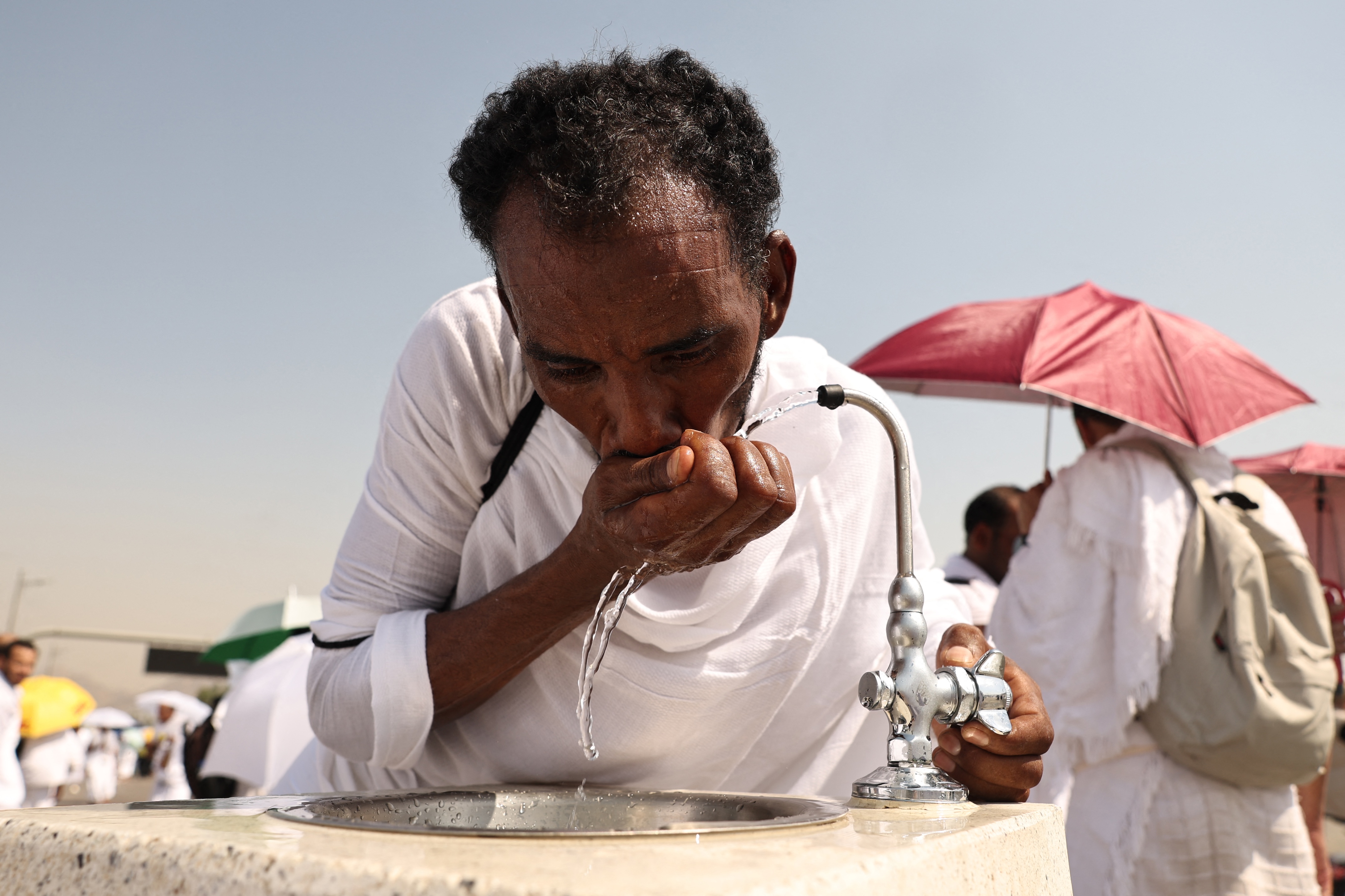 A Muslim pilgrim drinks from a water fountain at the base of Saudi Arabia's Mount Arafat during the climax of the Hajj pilgrimage. (AFP)