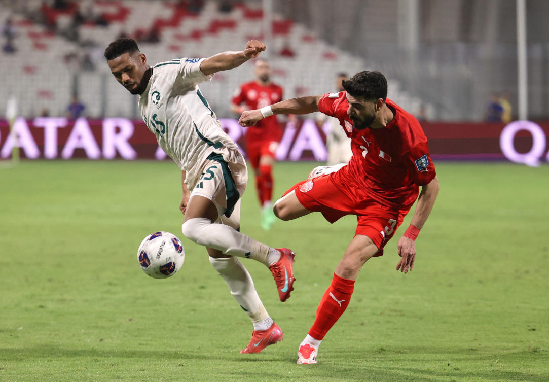 Saudi Arabia’s Aiman Yahya in action with Bahrain’s Waleed Al-Hayam during their World Cup — AFC Qualifiers — Group C — match at Bahrain National Stadium, Riffa, June 5, 2025. (Reuters)