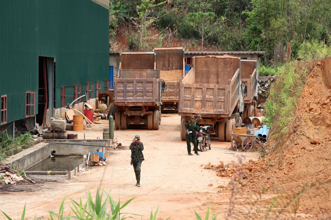 Members of the Kayan New Land Party standing guard near trucks at a China backed battery metal mine in Pekon township in Myanmar's eastern Shan State. (AFP)