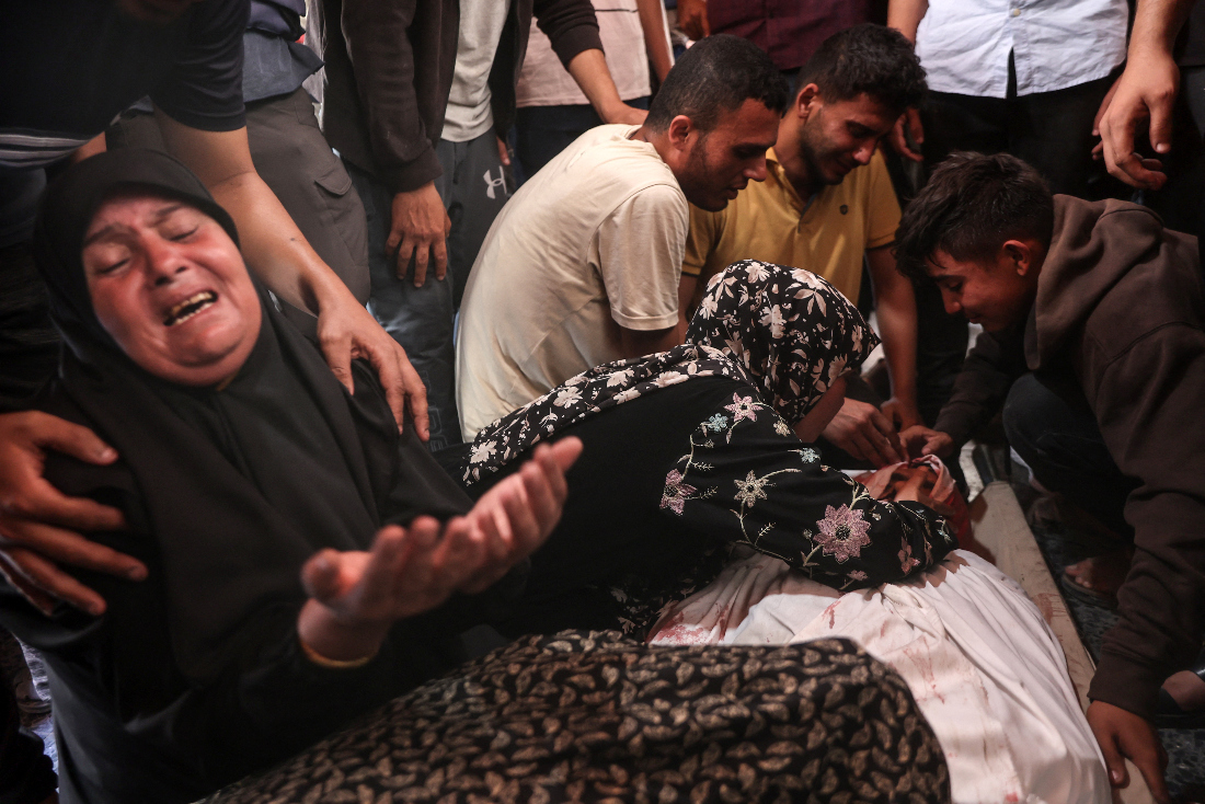 Mourners react over the body of one of three Palestinian journalists reportedly killed in Israeli bombardment in the yard of the Ahli Arab Hospital, in Gaza City on June 5, 2025. (AFP)