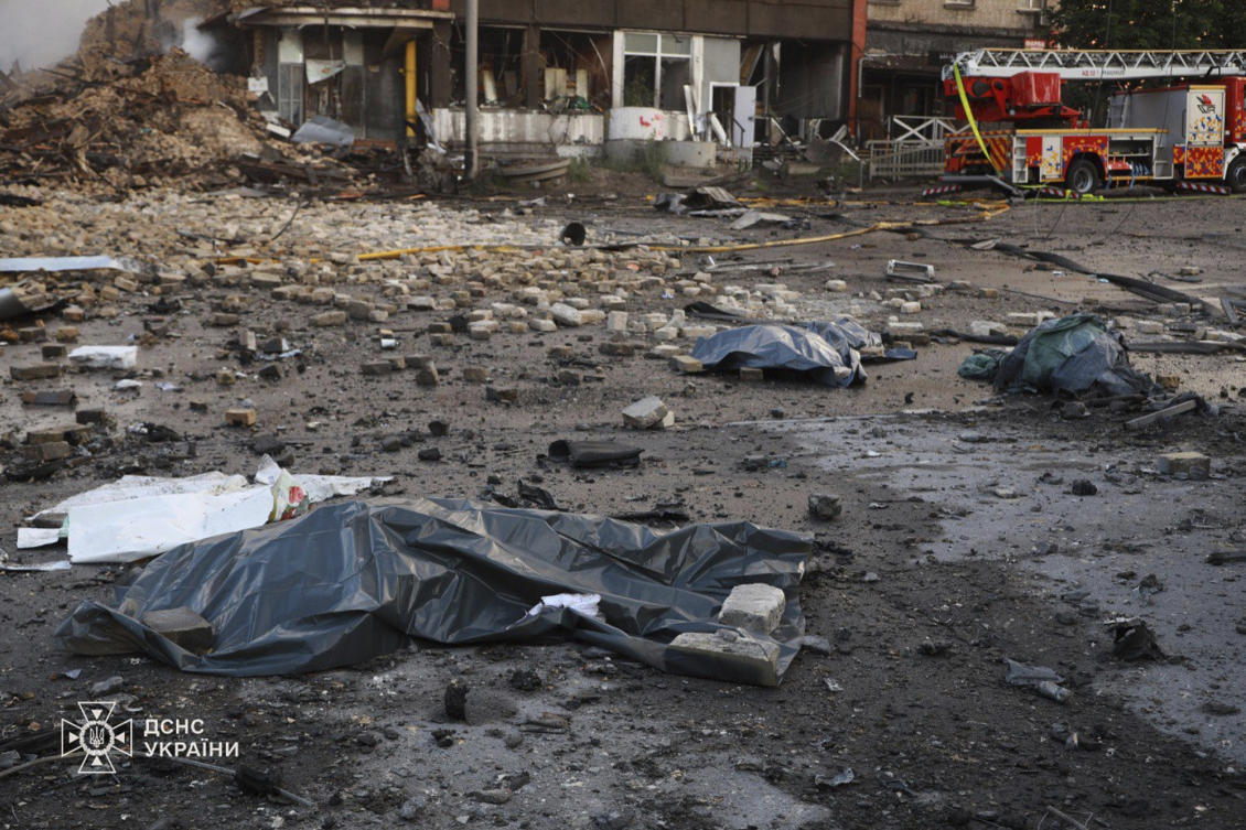 In this photo provided by the Ukrainian Emergency Service, covered bodies of three emergency workers killed in Russia’s missile attack lie in the damaged street in Kyiv, Jun. 6, 2025. (AP)
