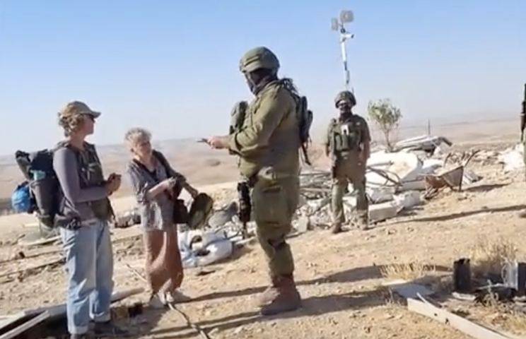 Video footage obtained by The Independent shows armed Israeli personnel holding the women’s passports. (Screenshot/ISM)