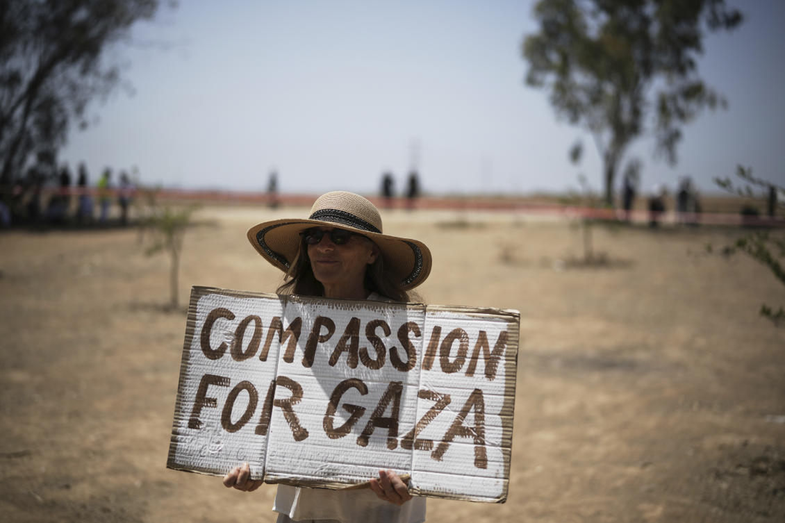 A woman holds a sign as peace activists march to call for an end to the war and starvation of civilians, near the Israel-Gaza border in southern Israel on June 6, 2025. (AP)