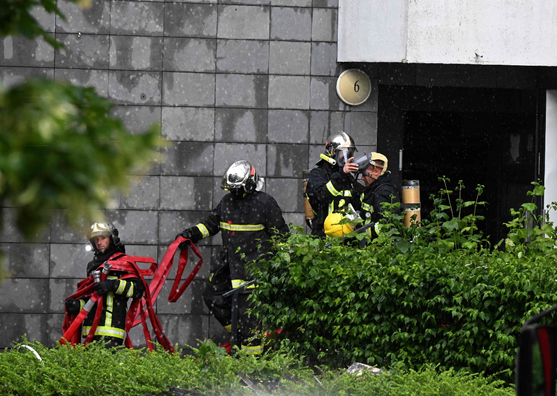 Fire fighters seen after extinguishing the fire that claimed the lives of four people in Reims, France. (AFP)