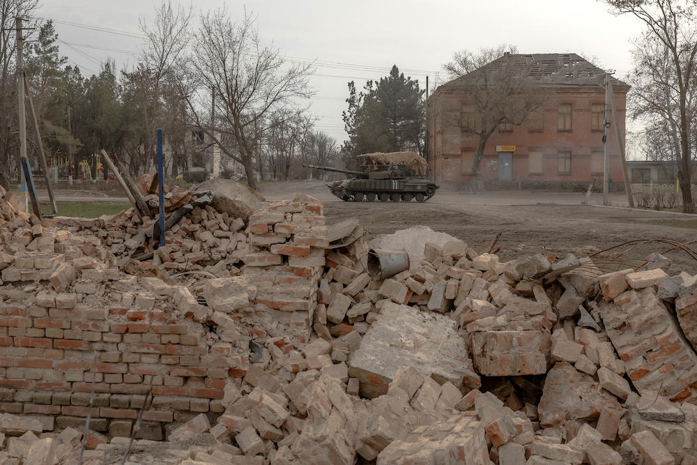 Above, a Ukrainian tank drives on a road past buildings damaged by shelling in a village in the Dnipropetrovsk region on March 16, 2025. (AFP)