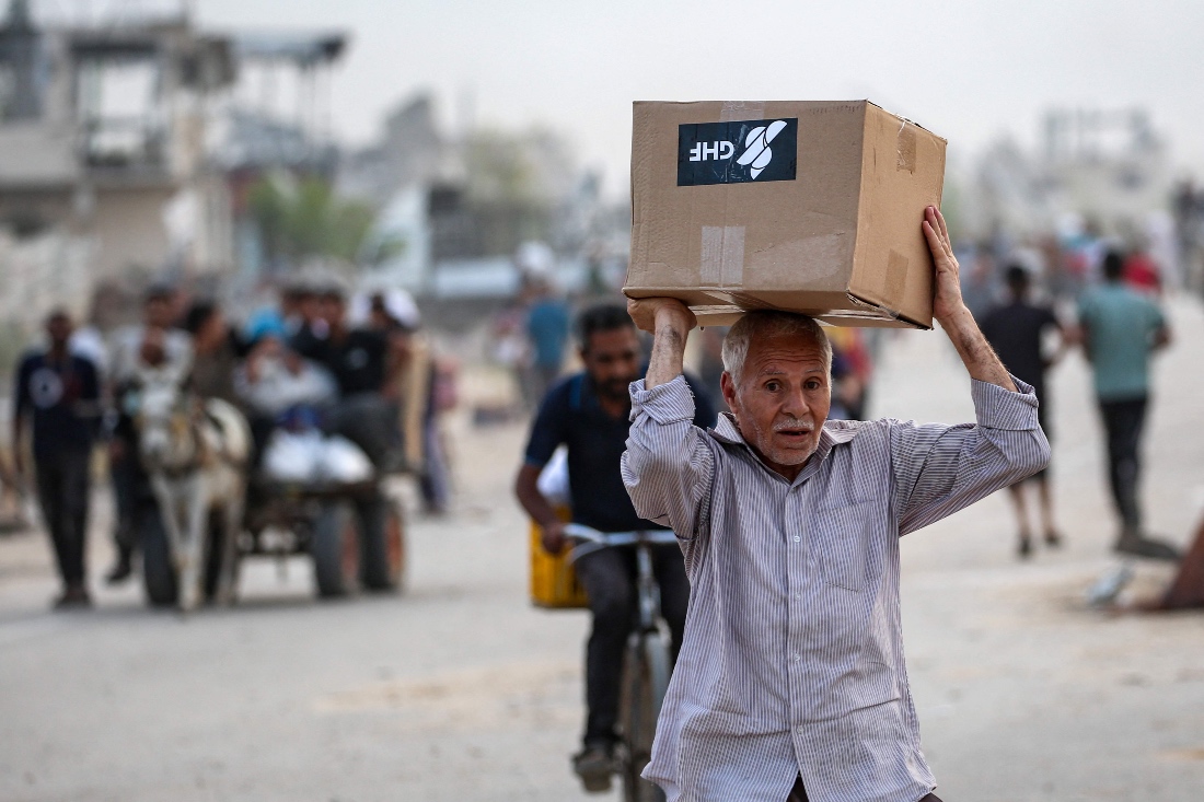 A man carries relief supplies from the Gaza Humanitarian Foundation in Gaza. (AFP)
