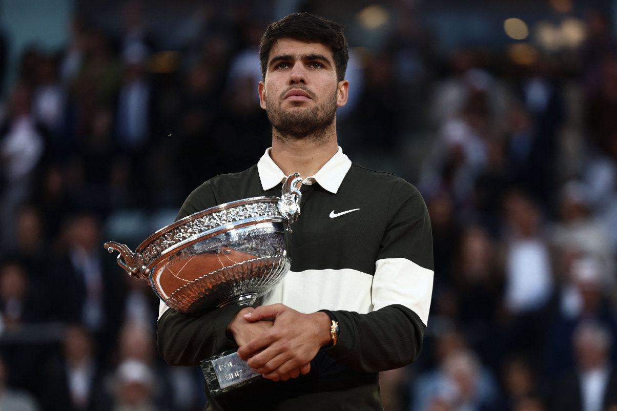 Spain's Carlos Alcaraz holds the trophy after winning the men's singles final match against Italy's Jannik Sinner on day 15 of the French Open tennis tournament on Court Philippe-Chatrier at the Roland-Garros Complex in Paris on June 8, 2025. (AFP)