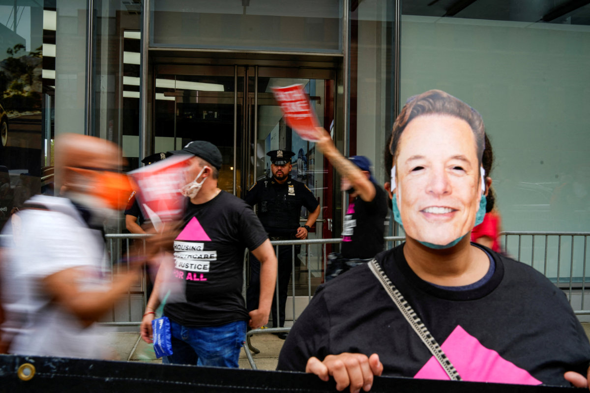 A New York Police Officer keeps an eye on protesters as they take part in a protest against Tesla and its CEO Elon Musk outside a Tesla store in New York City on June 7, 2025. (REUTERS)