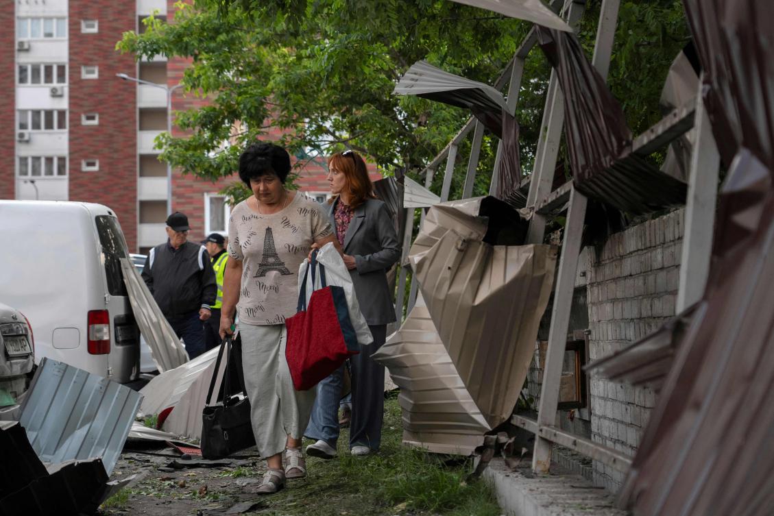 Local residents walk among debris in the courtyard of a damaged residential building following a drone attack in Kyiv on June 10, 2025, amid the Russian invasion in Ukraine.(AFP)