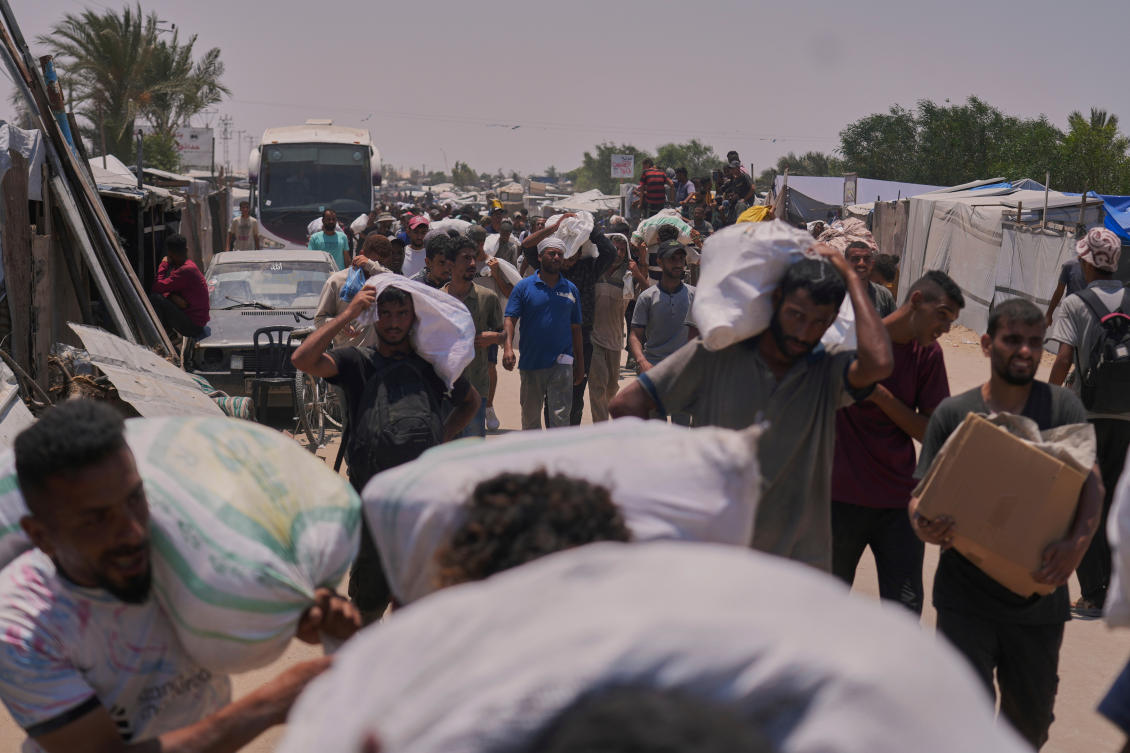 Palestinians carry bags containing food and humanitarian aid packages delivered by the Gaza Humanitarian Foundation, a U.S.-backed organization, in Rafah, southern Gaza Strip, Tuesday, June 10, 2025. (AP)