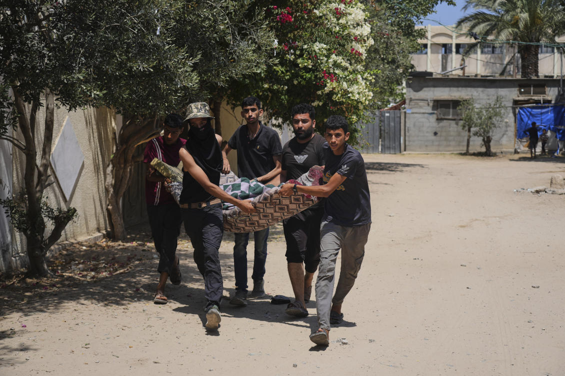 Palestinians carry the body of a person killed in an Israeli airstrike in Deir El-Balah, southern Gaza Strip, on Tuesday. (AP)