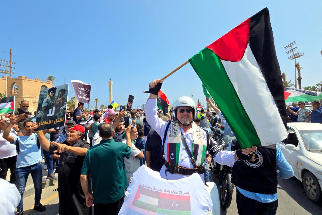 Activists, heading toward Gaza by land with the aim of breaking the siege on the Palestinian territory, are greeted by Libyans in Tripoli’s Martyrs Square. (AFP)