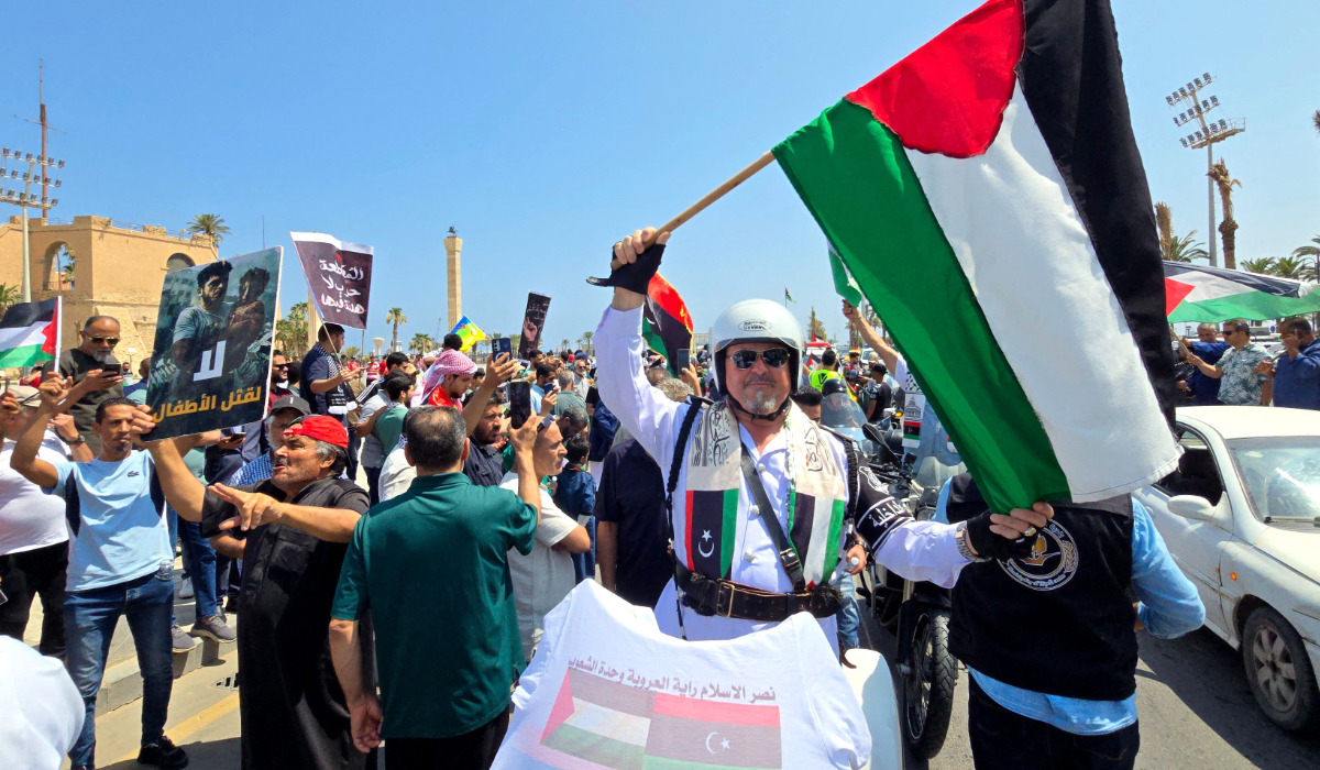 Activists, heading towards Gaza by land with the aim of breaking the siege on the Palestinian territory, are greeted by Libyans in Tripoli's Martyrs Square on June 11, 2025, one day after crossing into Libya from Tunisia. (AFP)