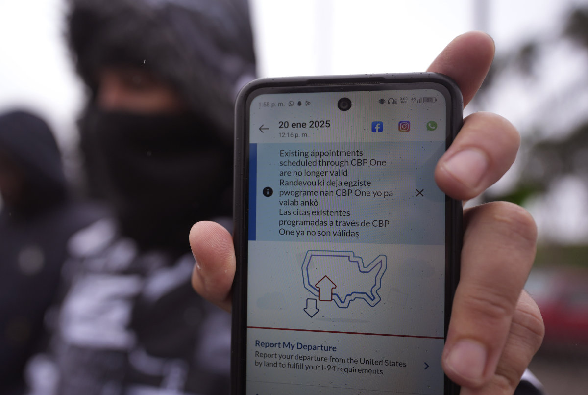 A migrant seeking asylum holds up the CBP One app showing his appointment was canceled after President Donald Trump was sworn into office on Jan. 20, 2025, in Matamoros, Mexico. (AP)