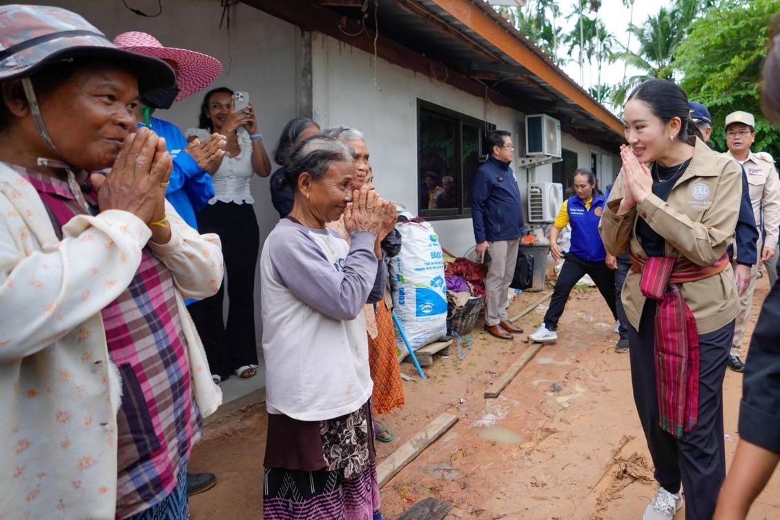 Thailand’s Prime Minister Paetongtarn Shinawatra, right, greets villagers during a visit to Kap Choeng District in Surin Province near the border with Cambodia on June 11, 2025. (Royal Thai Government/AFP)
