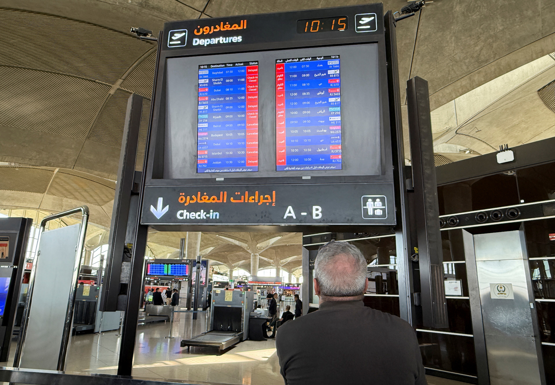 Flight information display screens show information about delayed and cancelled flights, at Queen Alia International Airport in Amman. (Reuters)