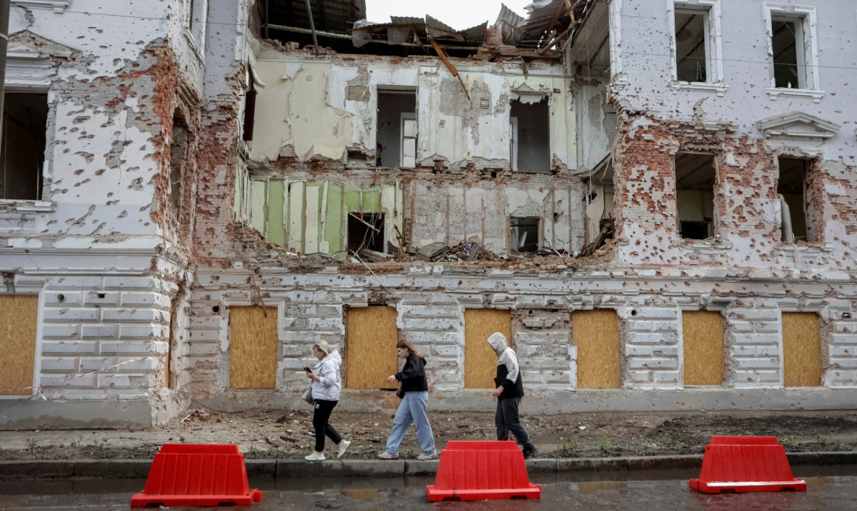 Residents walk near a damaged building in Sumy, Ukraine. (Reuters)