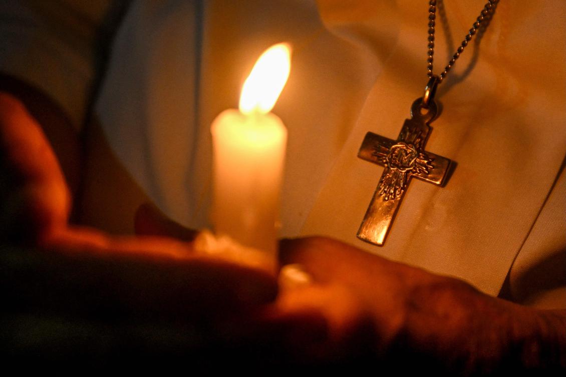 A member of the Christian community takes part in a candlelight prayer service for the victims of the Air India crash at Sacred Heart Cathedral in New Delhi on June 14, 2025. (AFP)