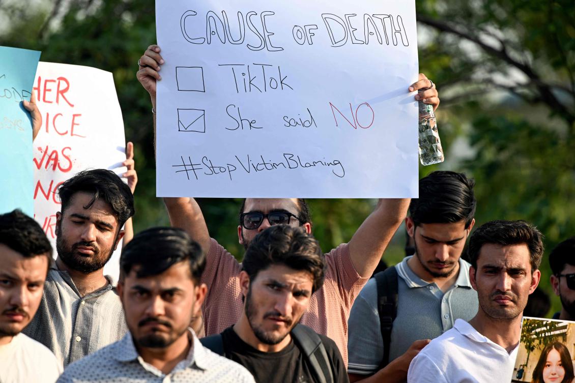 Demonstrators hold placards and a poster of TikTok star Sana Yousaf during a protest held to condemn violence against women in Islamabad on June 5, 2025. (AFP)