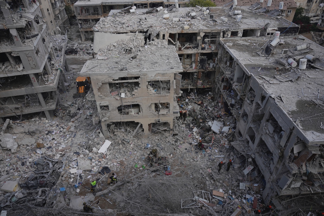 First responders work in a residential area hit by a missile fired from Iran near Tel Aviv, Israel. (AP)