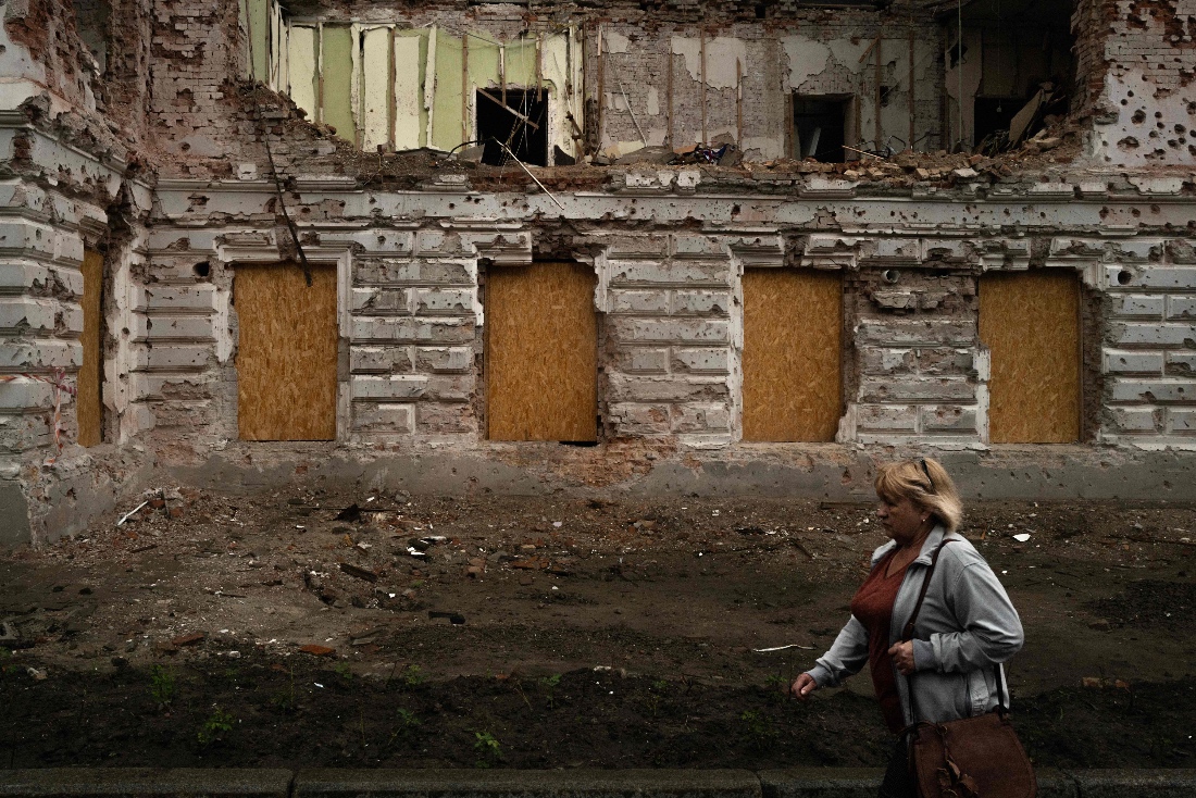 A woman walks in front of a monument destroyed by Russian bombing in Sumy, Ukraine. (AFP)