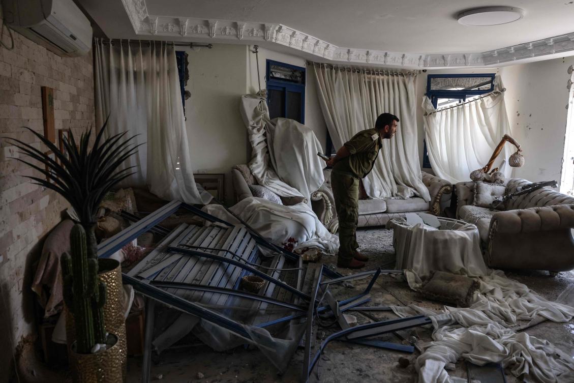 An Israeli sodlier checks the damage inside a flat in the northern Israeli town of Tamra, following an overnight missile attack from Iran on June 15, 2025, where four people, including a child, were reported killed. (AFP)