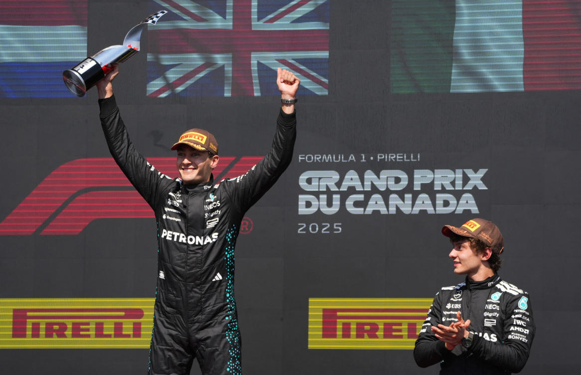 Mercedes' George Russell celebrates with the trophy on the podium after winning the Canadian Grand Prix with third placed Mercedes' Andrea Kimi Antonelli. (Reuters)