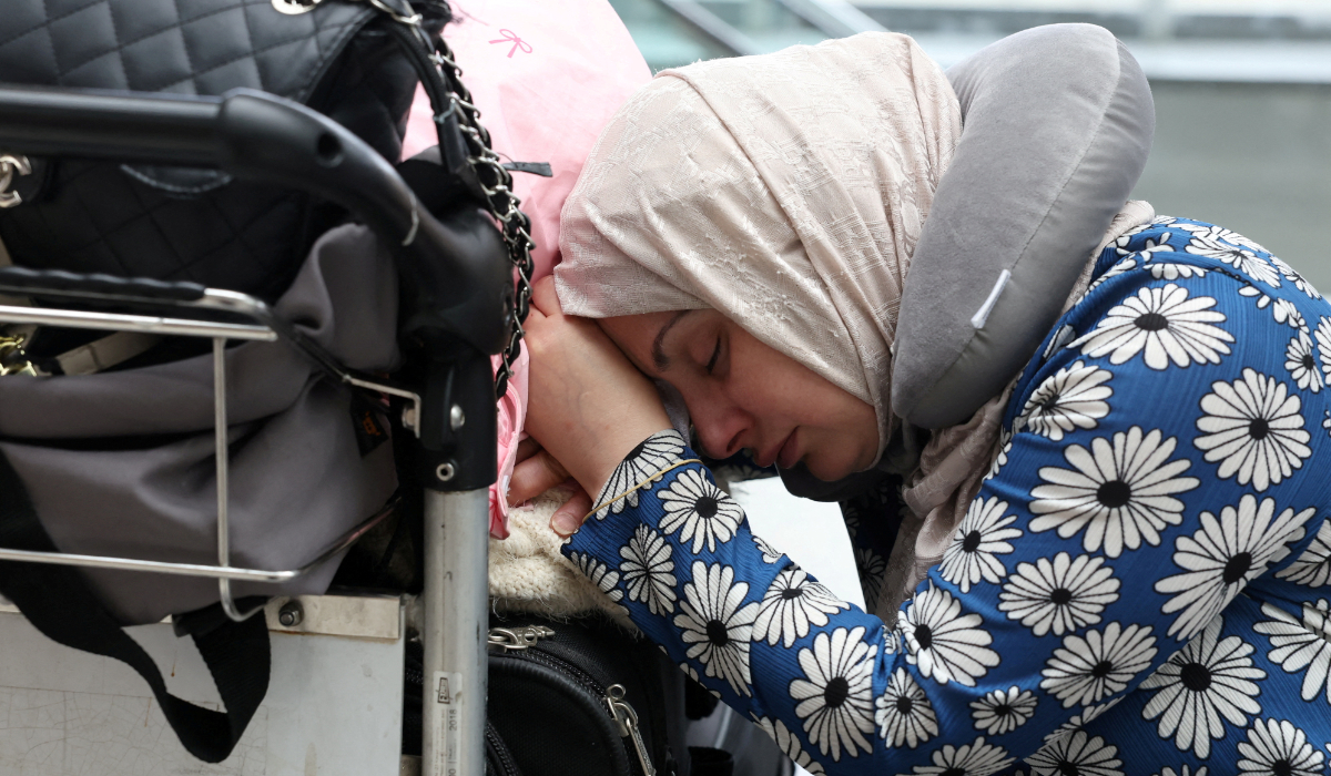 Rehab Rashid, who lives in Sweden, waits with her belongings at the departures area of Beirut-Rafic Hariri International Airport, during schedule disruptions stemming from the Iran-Israel conflict, in Lebanon June 16, 2025. (REUTERS)