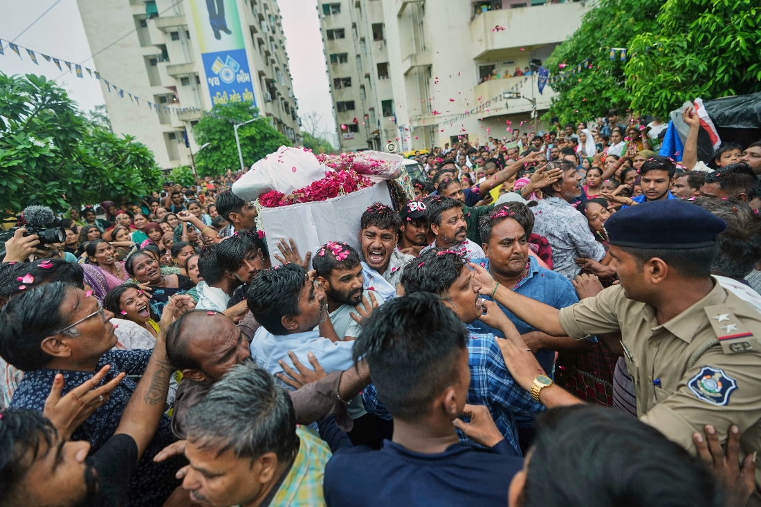 Mourners carry the coffin of Akash Patni a victim of the Air India plane crash, at his funeral procession in Ahmedabad, India. (