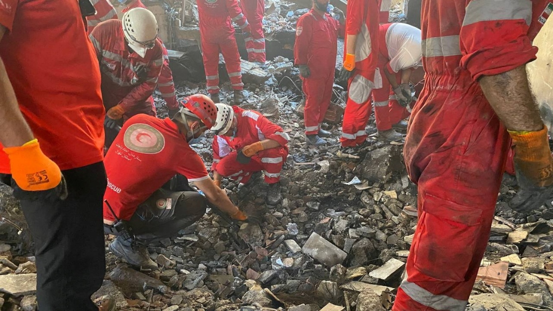 Iranian Red Crescent Society members search through the rubble for victims after Israeli strikes, at an unspecified location in Iran. (Reuters)