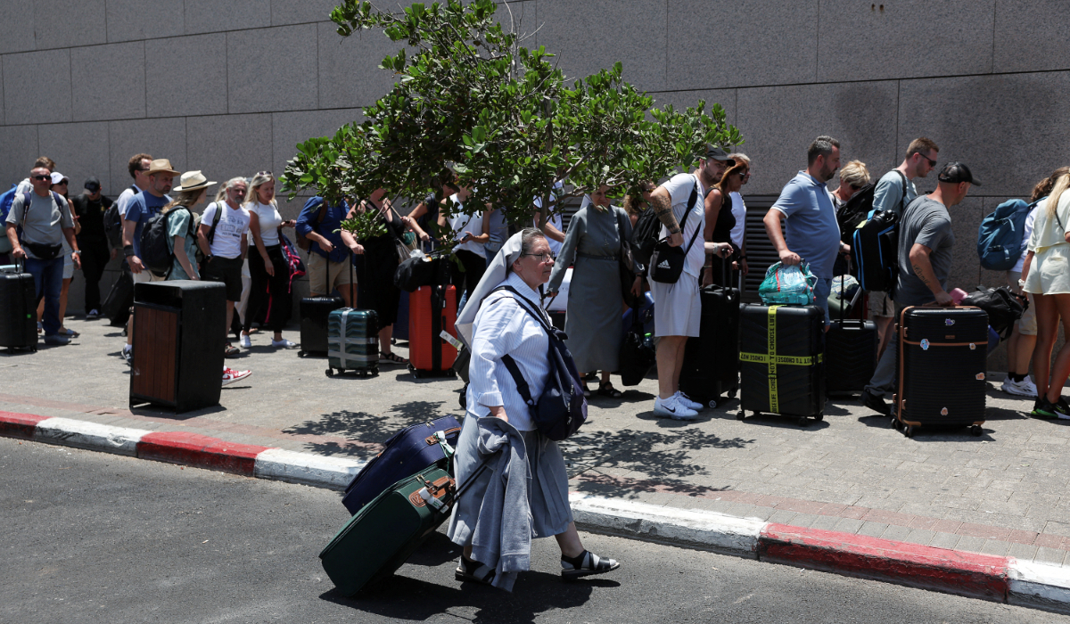 People with foreign nationalities gather to leave Israel on buses via Egypt, following a missile attack from Iran, in Tel Aviv, Israel, June 17, 2025. (REUTERS)