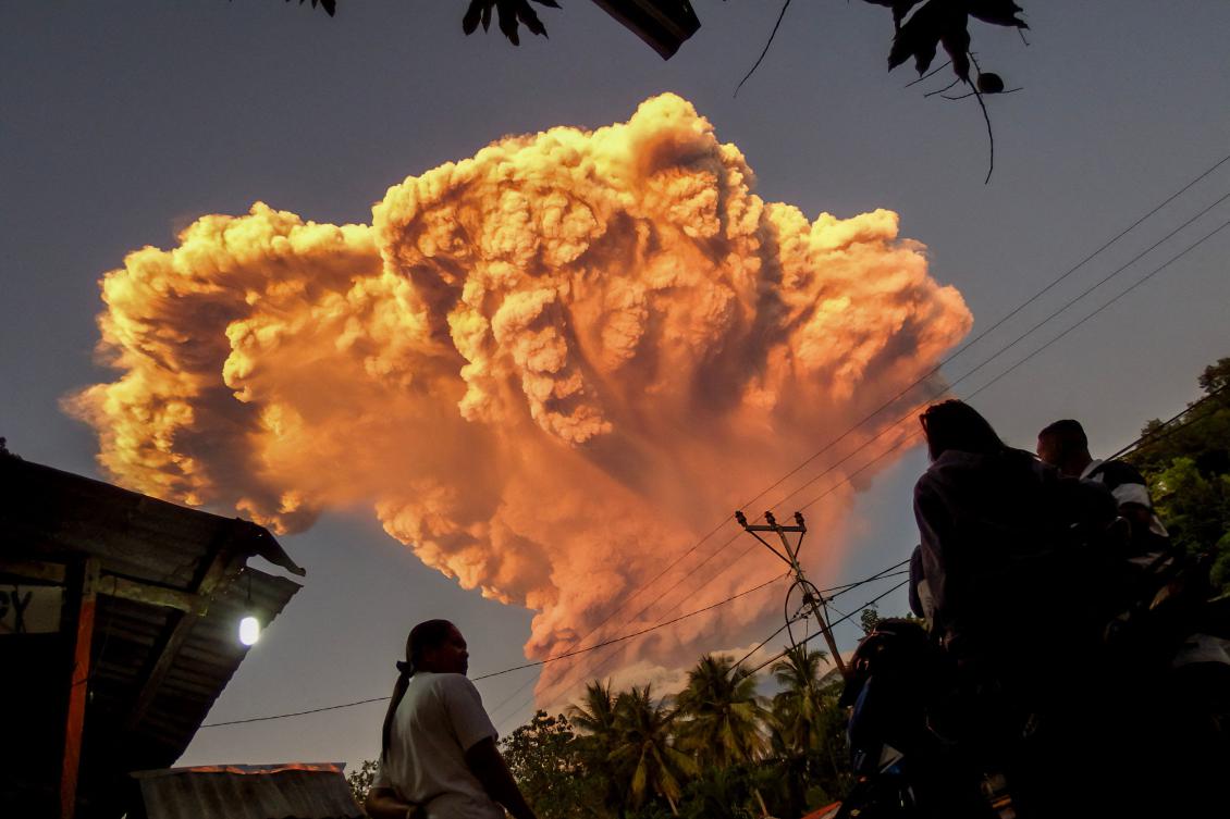 Villagers watch the eruption of Mount Lewotobi Laki-Laki as seen from Talibura village in Sikka, East Nusa Tenggara, on June 17, 2025. (AFP)