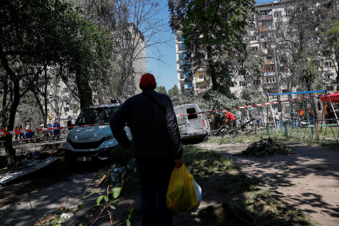 A resident watches as workers remove debris, at the site of an apartment building damaged on Tuesday during Russian drone and missile strikes, amid Russia’s attack on Ukraine, in Kyiv, Ukraine, June 18, 2025. (Reuters)