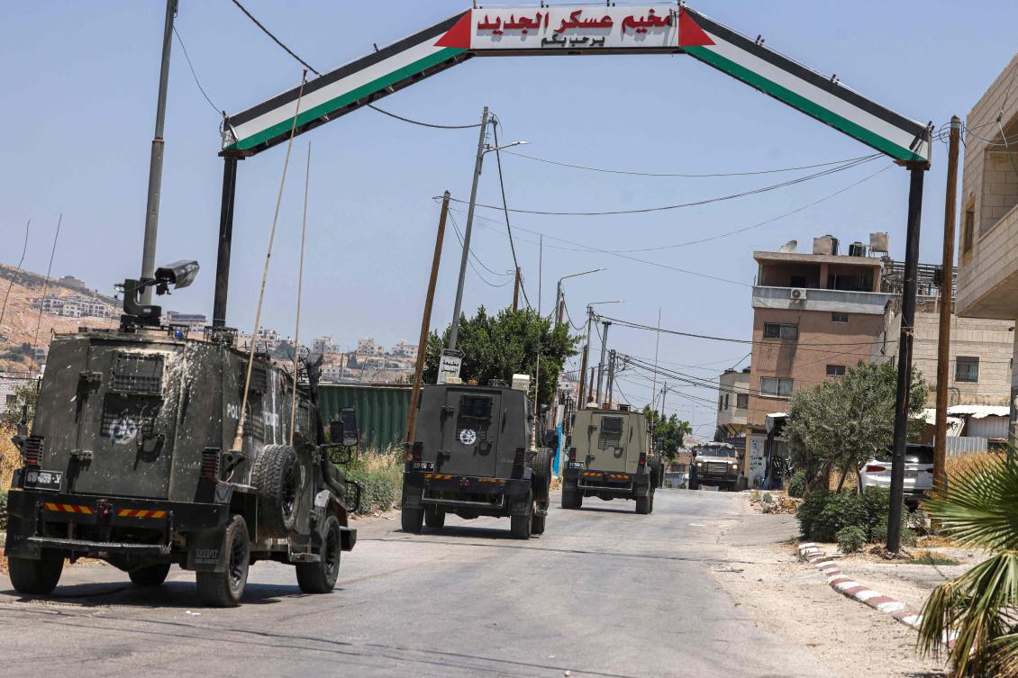 Israeli military vehicles drive into the Askar camp for Palestinian refugees east of Nablus in the occupied West Bank during a raid on June 16, 2025. (AFP)