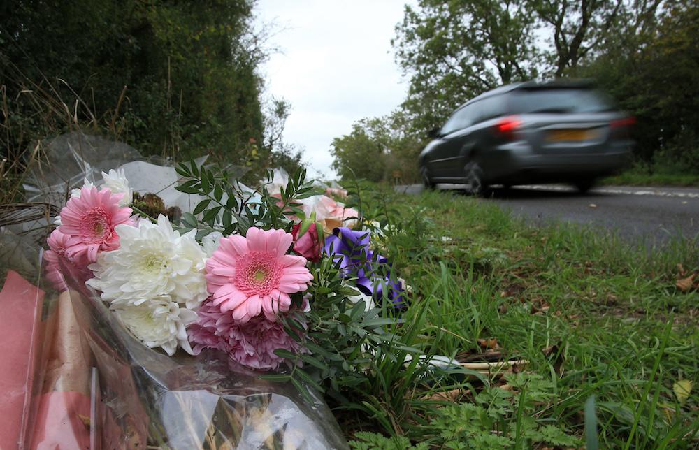 Above, floral tributes lay on the roadside near RAF Croughton in Northamptonshire, central England on Oct. 10, 2019, at the spot where teenager Harry Dunn was killed. (AFP file photo)