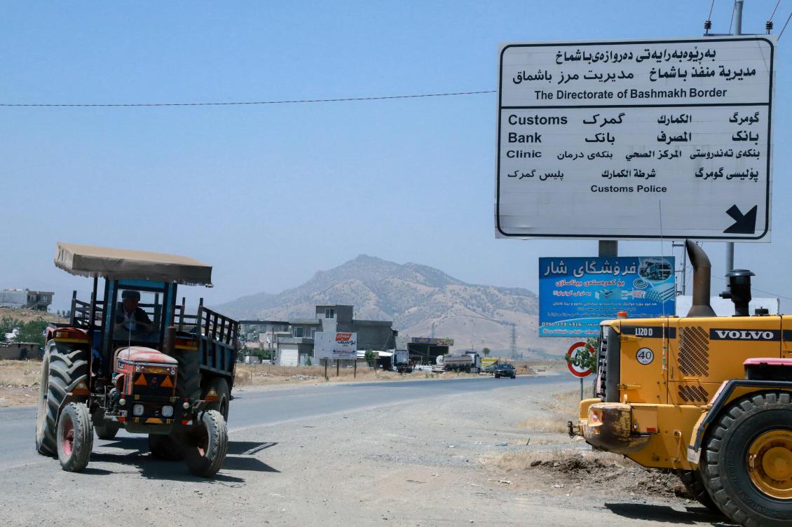 This picture shows a sign indicating the Bashmakh border crossing with Iran, in Penjwin district north of Sulaymaniyah, in Iraq's autonomous Kurdistan region. (AFP)