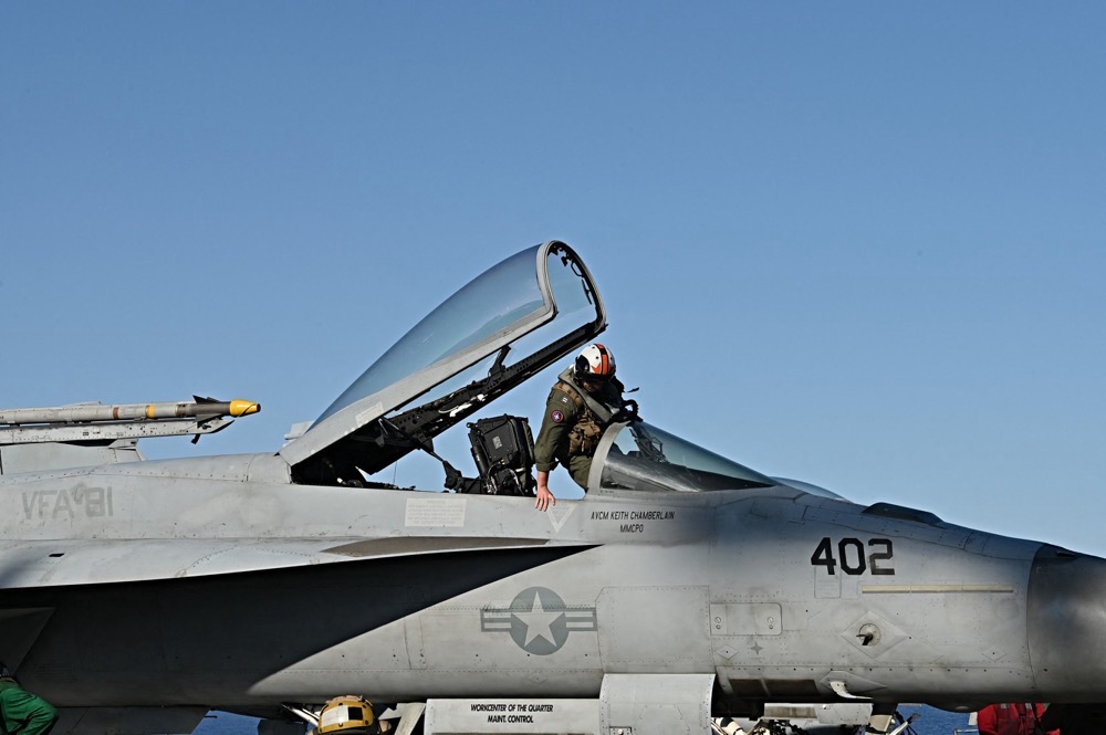 A pilot enters a F/A-18 Hornet jet as it prepares to take off from the deck of aircraft carrier USS Harry S Truman. (AFP file photo)