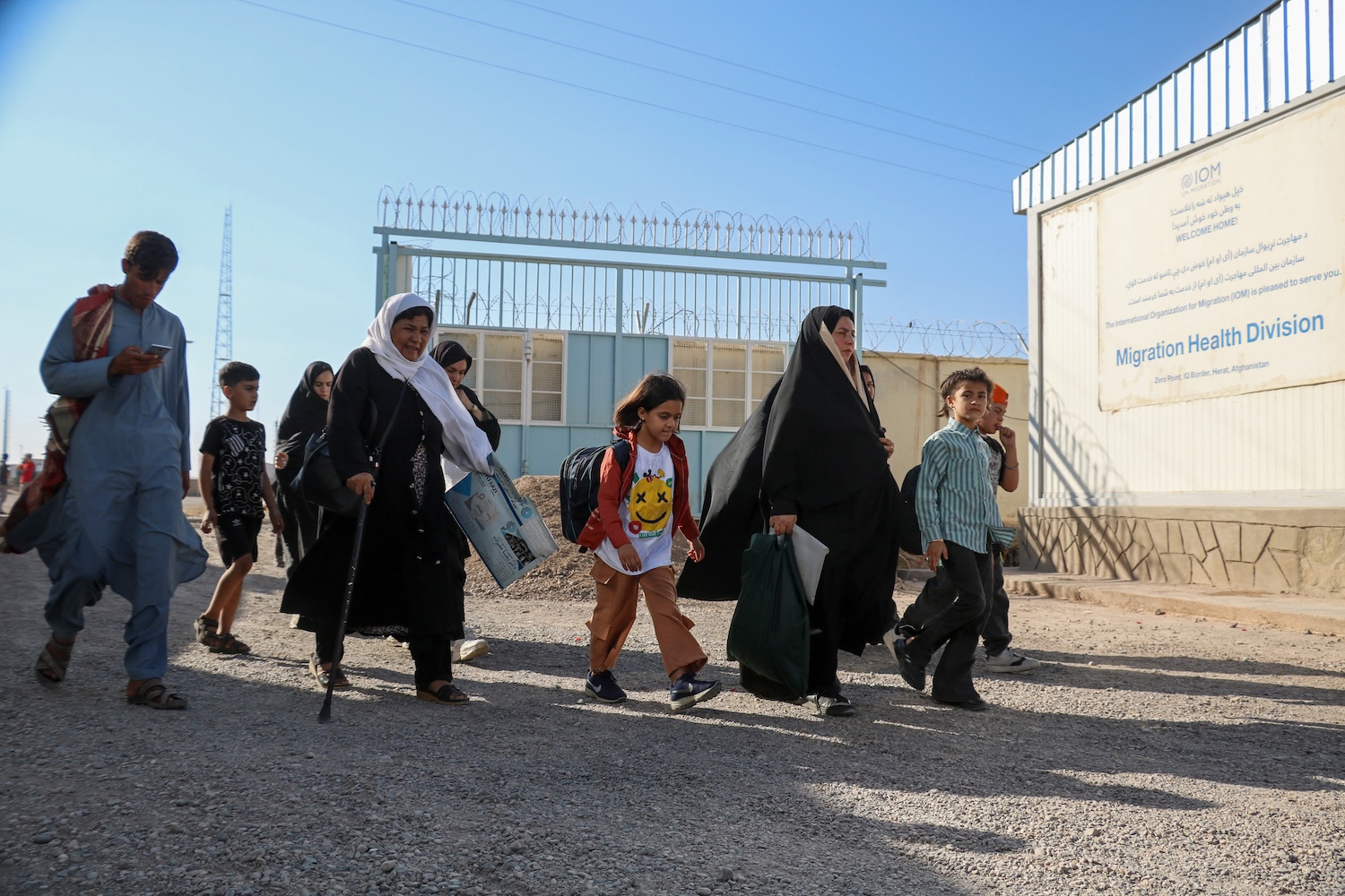 In this file photo taken on Sept. 12, 2024, Afghans walk to a registration center near the Afghanistan-Iran border in the Islam Qala district of Herat province. (AFP/File)