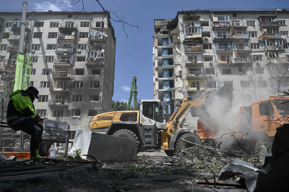 A Ukrainian rescuer rests as the search operations continue at the site of a residential building, heavily damaged following a Russian missile strike the previous day, in Kyiv on Jun. 18, 2025. (AFP)