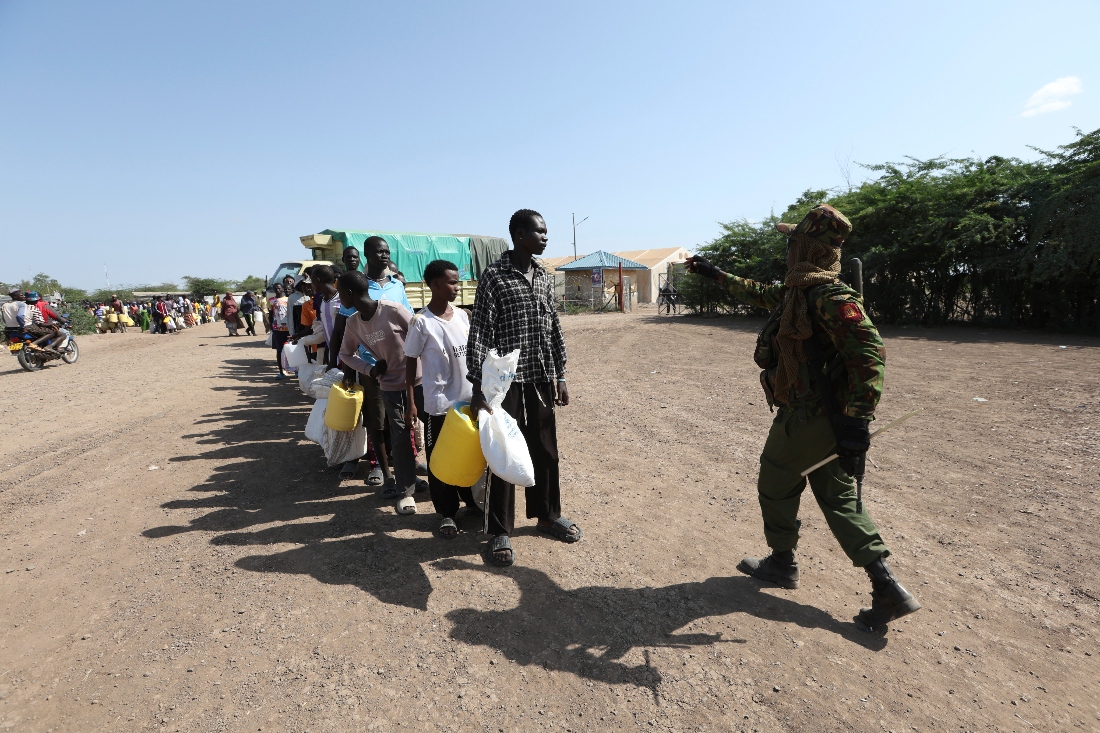 Refugees queue to receive humanitarian aid distributed by the World Food Programme at Kakuma Refugee Camp in Turkana, Kenya. (AP)