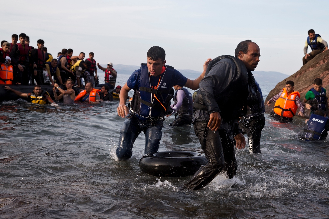 Migrants and refugees arrive on a dinghy after crossing from Turkiye to Lesbos island, Greece, 2015. (AP)
