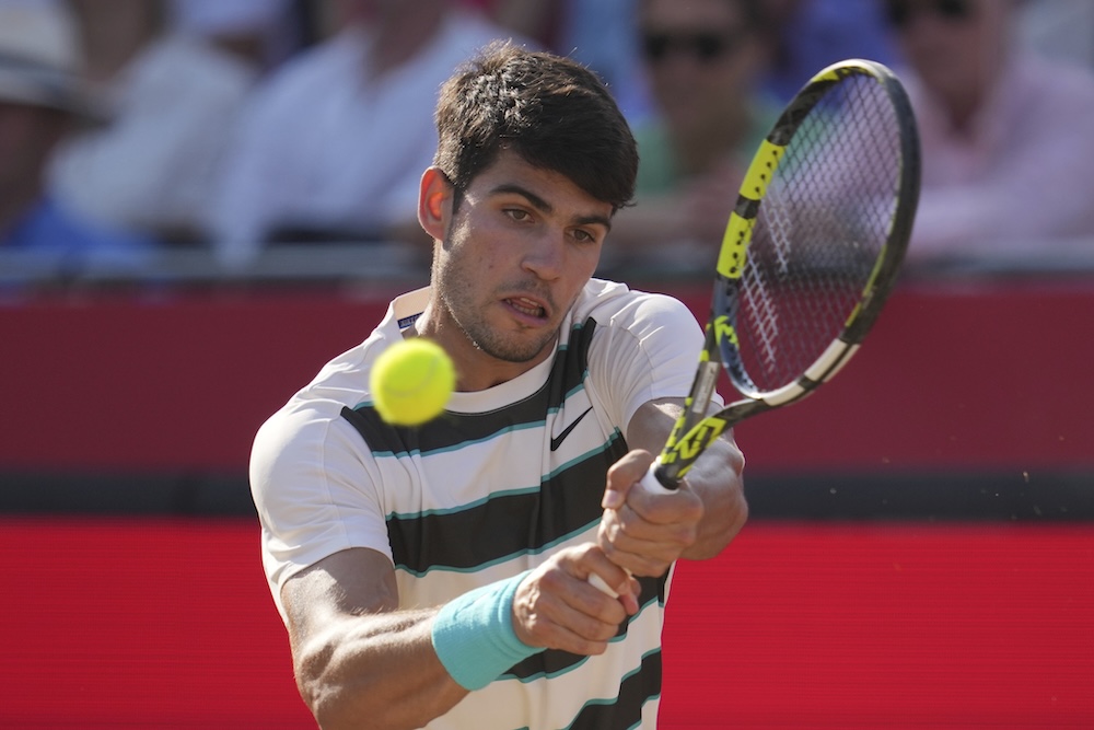 Carlos Alcaraz of Spain plays a return to Arthur Rinderknech of France during their quarterfinal match at the Queen’s Club Championships tennis tournament in London Friday. (AP)